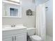 Clean bathroom with a shower, toilet, and white vanity at 4155 S Atlantic Ave # 111, New Smyrna Beach, FL 32169