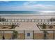 Direct beach access with a gated entrance and outdoor seating at 4155 S Atlantic Ave # 111, New Smyrna Beach, FL 32169