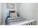 Charming bedroom with a twin bed, accent pillows, and nautical-themed art at 4155 S Atlantic Ave # 111, New Smyrna Beach, FL 32169