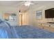 Cozy bedroom featuring a beach-themed decor, dresser, and large TV at 4155 S Atlantic Ave # 111, New Smyrna Beach, FL 32169