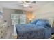 Bright bedroom features a large window, a ceiling fan, and a comfortable bed at 4155 S Atlantic Ave # 111, New Smyrna Beach, FL 32169