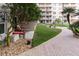 Beautiful condo complex with manicured landscaping and a brick walkway at 4155 S Atlantic Ave # 111, New Smyrna Beach, FL 32169