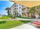 Beautiful condo building with lush landscaping and patio seating at 4155 S Atlantic Ave # 111, New Smyrna Beach, FL 32169