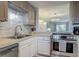 Modern kitchen features stainless steel appliances and stylish backsplash at 4155 S Atlantic Ave # 111, New Smyrna Beach, FL 32169