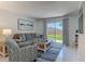 Comfortable living room with access to an outdoor patio and a view at 4155 S Atlantic Ave # 111, New Smyrna Beach, FL 32169