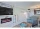 Inviting living room with a fireplace and view to an adjacent dining area at 4155 S Atlantic Ave # 111, New Smyrna Beach, FL 32169