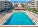 Inviting pool area with lounge chairs and well-maintained landscaping at 4155 S Atlantic Ave # 111, New Smyrna Beach, FL 32169
