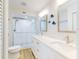 Bright bathroom featuring a double sink vanity with white cabinets and a walk-in shower at 454 Bouchelle Dr # 202, New Smyrna Beach, FL 32169