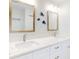 A double sink vanity with white marble countertops and a decorative fish theme wall design at 454 Bouchelle Dr # 202, New Smyrna Beach, FL 32169