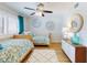 Charming bedroom featuring twin beds, decorative wall art, and ample natural light at 454 Bouchelle Dr # 202, New Smyrna Beach, FL 32169
