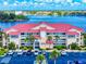Beautiful waterfront condo with a red roof, parking and palm trees in a well-maintained community at 454 Bouchelle Dr # 202, New Smyrna Beach, FL 32169