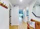 Bright hallway features wood floors, and a view into the main living area at 454 Bouchelle Dr # 202, New Smyrna Beach, FL 32169