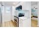 Well-lit kitchen features stainless steel appliances, custom cabinets, and an electric stove at 454 Bouchelle Dr # 202, New Smyrna Beach, FL 32169