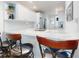 Kitchen with white cabinets, stainless appliances and breakfast bar with bar stool seating at 454 Bouchelle Dr # 202, New Smyrna Beach, FL 32169