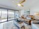 Cozy living room with comfortable seating, a stylish coffee table, and sliding glass doors opening to a balcony at 454 Bouchelle Dr # 202, New Smyrna Beach, FL 32169