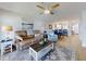 Open-concept living room with modern furniture, view of the dining area, and ample natural light at 454 Bouchelle Dr # 202, New Smyrna Beach, FL 32169