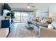 Spacious living room features modern furnishings and a large sliding door to the balcony with scenic view at 454 Bouchelle Dr # 202, New Smyrna Beach, FL 32169