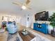 Bright and airy living room with a modern entertainment center, comfortable seating, and open access to the dining area at 454 Bouchelle Dr # 202, New Smyrna Beach, FL 32169