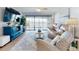 Comfortable living room featuring a plush sofa, stylish decor, and sliding glass doors leading to a balcony with a view at 454 Bouchelle Dr # 202, New Smyrna Beach, FL 32169
