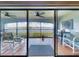 Enjoy water views from this tiled patio with chairs, table and ceiling fans at 454 Bouchelle Dr # 202, New Smyrna Beach, FL 32169