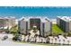 Aerial view showcases a beachfront condo building with well-maintained landscaping and parking at 4555 S Atlantic Ave # 4310, Port Orange, FL 32127