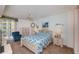 Inviting bedroom with balcony access, featuring carpeted floor, queen bed, and soft lighting at 4555 S Atlantic Ave # 4310, Port Orange, FL 32127