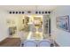Bright dining room with a glass top table, white wicker chairs, and decorative wall art, creating an inviting atmosphere at 4555 S Atlantic Ave # 4310, Port Orange, FL 32127