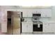 Modern kitchen featuring stainless steel appliances, white cabinetry, and ample countertop space, creating a functional cooking area at 4555 S Atlantic Ave # 4310, Port Orange, FL 32127