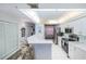 Open kitchen design with white cabinets, breakfast bar, and stainless steel appliances, seamlessly connecting to the dining area at 4555 S Atlantic Ave # 4310, Port Orange, FL 32127
