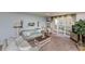 Living room with ceiling fan and sliding doors to balcony overlooking the ocean at 4555 S Atlantic Ave # 4310, Port Orange, FL 32127