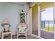 Cozy chair with a table next to the sliding glass door to the balcony at 4555 S Atlantic Ave # 4310, Port Orange, FL 32127
