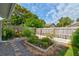 View of the backyard with a garden, gravel walkway, and wooden fence at 5146 Pineland Ave, Port Orange, FL 32127