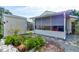 View of the backyard from the side of the home showcasing garden, shed and screened in patio at 5146 Pineland Ave, Port Orange, FL 32127