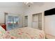 Bedroom featuring a slider to an outdoor space, vaulted ceiling, and a closet with shelving at 5146 Pineland Ave, Port Orange, FL 32127