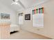 Neutral bedroom featuring two windows with colorful valances and coastal-themed artwork at 5146 Pineland Ave, Port Orange, FL 32127