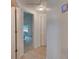 Clean hallway leading to a bedroom with natural light and featuring tile flooring and closet space at 5146 Pineland Ave, Port Orange, FL 32127
