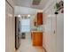 Functional kitchen area with stainless steel appliances, tile flooring, and ample storage space at 5146 Pineland Ave, Port Orange, FL 32127