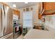 Cozy kitchen with stainless steel appliances, warm wood cabinets, and natural light from the window at 5146 Pineland Ave, Port Orange, FL 32127