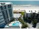 Aerial view showcasing the property's proximity to the beach, pool, and surrounding amenities at 5207 S Atlantic Ave # 224, New Smyrna Beach, FL 32169