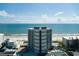 Aerial view of the high-rise condo with beach access, pool, and scenic ocean views at 5207 S Atlantic Ave # 224, New Smyrna Beach, FL 32169