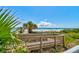 Elevated boardwalk providing easy access to the beach, surrounded by lush greenery at 5207 S Atlantic Ave # 224, New Smyrna Beach, FL 32169