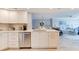 Bright, white kitchen with stainless steel appliances and open view to the living and dining areas at 5207 S Atlantic Ave # 224, New Smyrna Beach, FL 32169