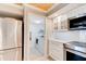 Well-equipped kitchen with stainless appliances and access to a convenient laundry room at 5207 S Atlantic Ave # 224, New Smyrna Beach, FL 32169