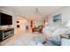 Bright living room with beachy decor, comfortable seating, and a view to the dining area at 5207 S Atlantic Ave # 224, New Smyrna Beach, FL 32169