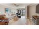 Comfortable living room with coastal decor and a balcony access for outdoor enjoyment at 5207 S Atlantic Ave # 224, New Smyrna Beach, FL 32169