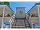 Walkway leading to the beach, highlighted by beachy decorations and convenient seating at 5207 S Atlantic Ave # 224, New Smyrna Beach, FL 32169