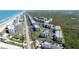 Aerial view of condo complex near beach with lush greenery and convenient parking at 5300 S Atlantic Ave # 5-502, New Smyrna Beach, FL 32169