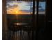 Balcony with sunset views and cozy seating arrangement offers a peaceful outdoor retreat at 5300 S Atlantic Ave # 5-502, New Smyrna Beach, FL 32169