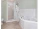 Clean bathroom featuring a corner soaking tub and glass-enclosed shower at 5300 S Atlantic Ave # 5-502, New Smyrna Beach, FL 32169