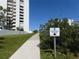 Ocean Walk Condos beach access with beautiful condo building and lush green landscape at 5300 S Atlantic Ave # 5-502, New Smyrna Beach, FL 32169